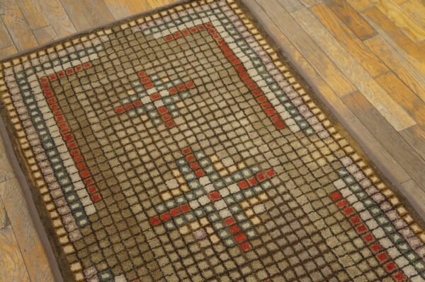 This brown and beige high-pile rug features a multi-colored geometric square pattern on wooden flooring.