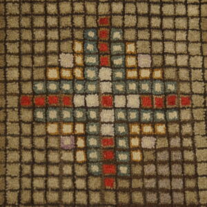 Textured rug detail features a grid pattern in taupe and brown with a multicolor diamond motif.
