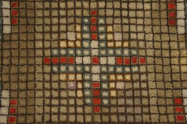 Textured rug detail features a grid pattern in taupe and brown with a multicolor diamond motif.