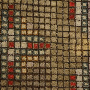 The square-grid texture of this rug features brown, tan, red, blue, and purple accents.