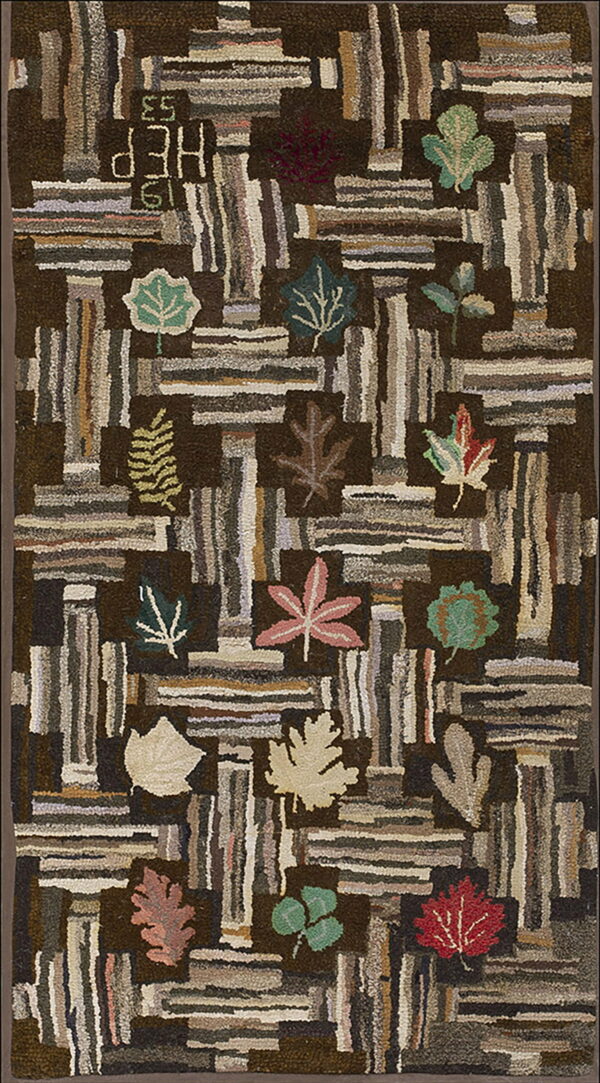 Hooked brown rug with chunky pile, featuring variegated vertical blocks, colorful leaves, and "hep 1953" text.