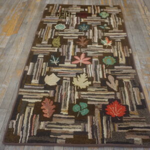 Brown log cabin runner rug with scattered colorful leaves rests on distressed gray wood flooring.