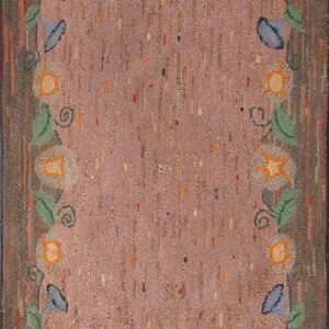 High-texture rug featuring a dusty rose field, vertical dashes, and a winding floral border of leaves and blossoms.