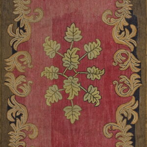 Hooked rug featuring a mottled pink field, a central yellow-green leaf cluster, and an elaborate gold acanthus border.