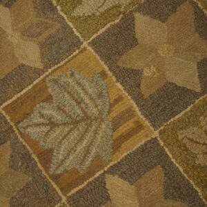 High-texture rug with a diamond grid pattern featuring large earth-toned leaves and star shapes.