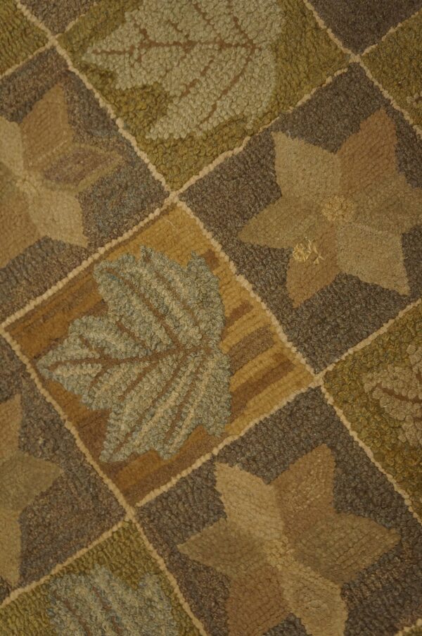 High-texture rug with a diamond grid pattern featuring large earth-toned leaves and star shapes.