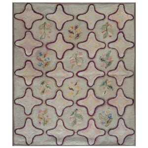 Light gray hooked rug with a purple quatrefoil trellis and small pastel floral designs.