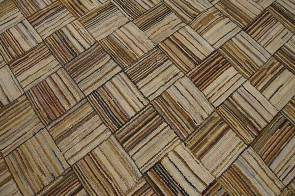 Rustic beige and brown striped patches form a chunky, textural herringbone pattern across the rug surface.