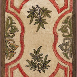 Textured rug with red geometric framing around a cream field decorated with green foliage.