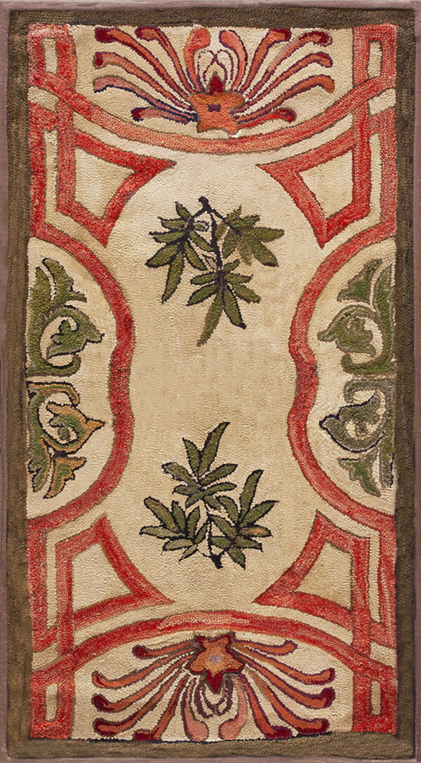 Textured rug with red geometric framing around a cream field decorated with green foliage.