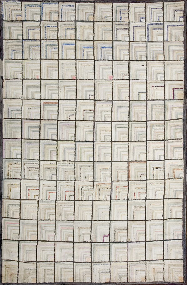 Chunky textured rug featuring a dark gray grid over squares filled with nested light gray geometric shapes.