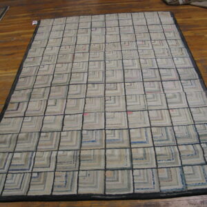 Low-pile rug with a grid of beige and gray concentric squares outlined in dark gray on wood floors.
