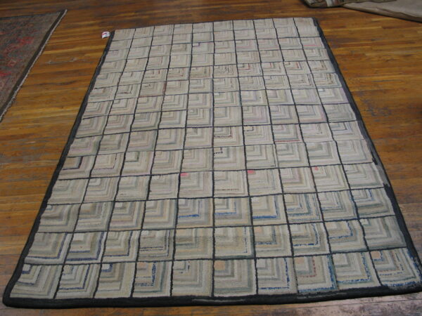 Low-pile rug with a grid of beige and gray concentric squares outlined in dark gray on wood floors.