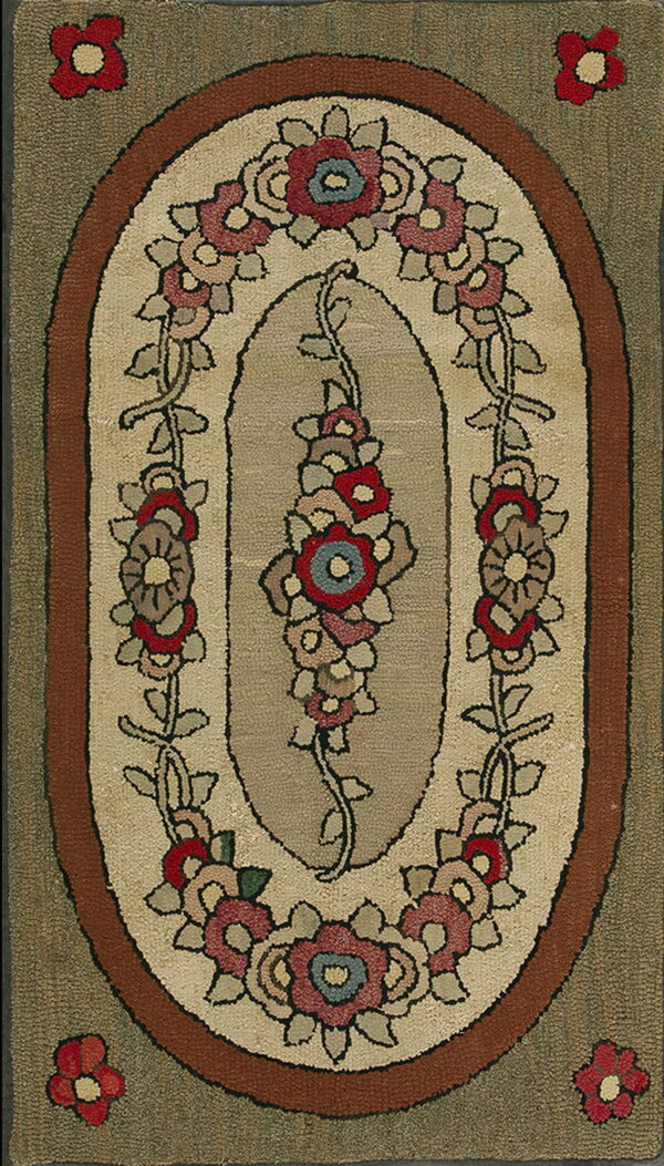 Textured oblong rug with a floral medallion in tan, red, and blue, surrounded by a rusty brown and olive border.