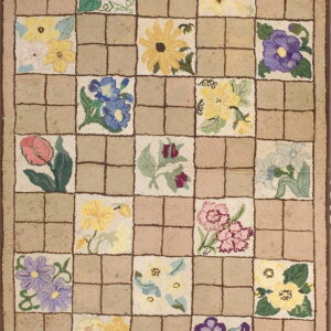 This beige rug has a checkered pattern alternating solid squares with squares holding detailed multicolor floral motifs.