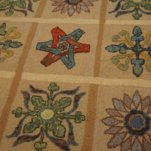 Textured beige rug featuring multicolored flower and star motifs set within a light brown grid pattern.