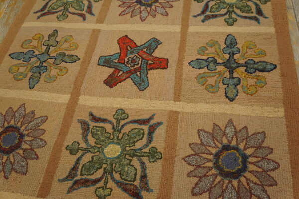 Textured beige rug featuring multicolored flower and star motifs set within a light brown grid pattern.