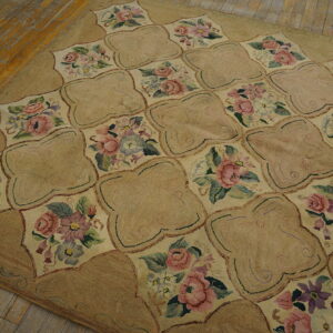 Floral lattice rug in tan and cream with pink and purple flowers on rustic wood planks.