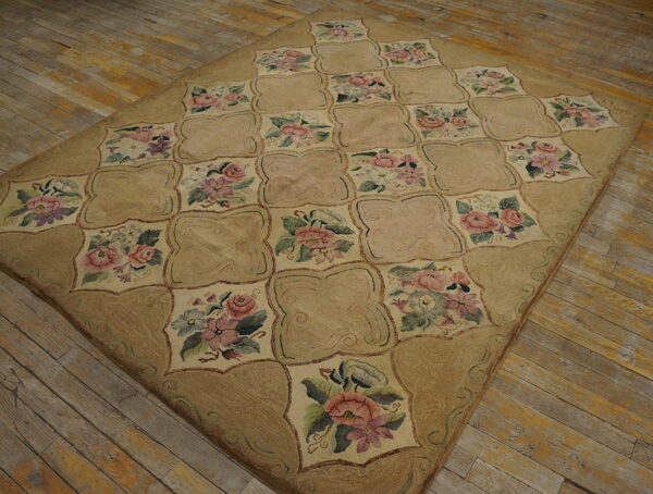 A tan plush rug with a floral quatrefoil grid pattern lies on distressed wooden floorboards.