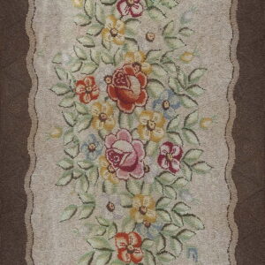 A textured beige runner with a dense, colorful floral bouquet and wide, dark brown outer borders.