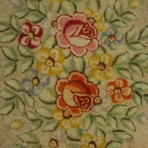 Looped pile rug displaying a vibrant floral bouquet with pink, orange, yellow, blue, and green colors on beige.