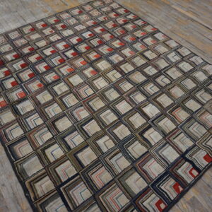 Textured rug featuring multicolored concentric squares over distressed gray and brown wooden planks.