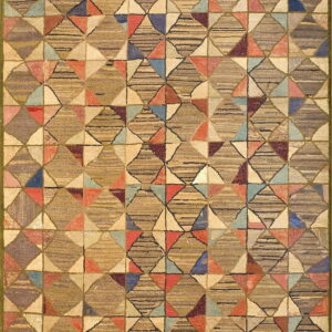 Earth-toned textured rug with a repeating patchwork diamond pattern accented by multicolored triangles.