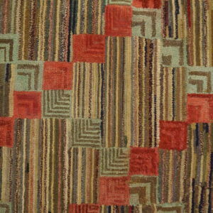 Geometric rug with rust red squares, L-shaped sage patterns, and vertical multicolor stripes on wood floor.