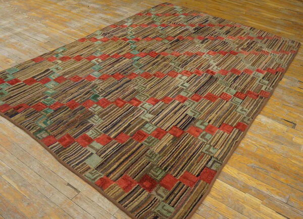 Textured rug with diagonal brown stripes and repeating red and teal geometric square accents on hardwood.