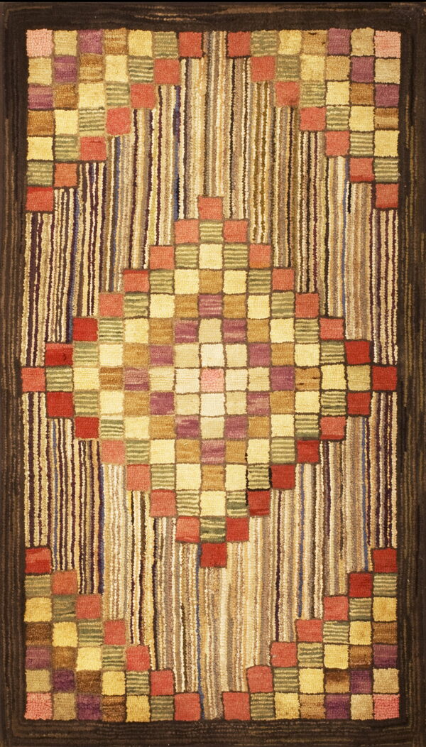 Textured rug featuring a central diamond of multicolored squares against a vertically striped field and dark border.