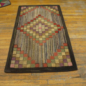 Textured runner featuring red, purple, and green squares forming a diamond pattern on a striped background, placed on wood flooring.