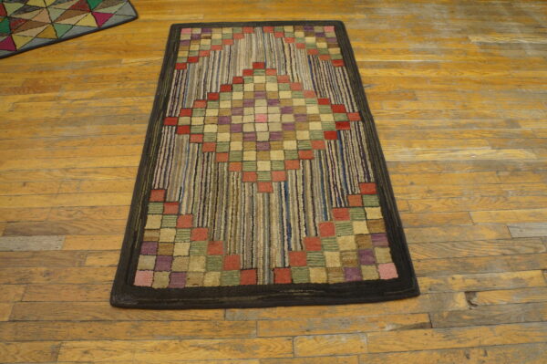 Textured runner featuring red, purple, and green squares forming a diamond pattern on a striped background, placed on wood flooring.