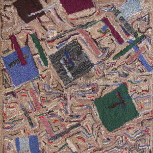 Textured rug featuring an abstract patchwork pattern with dark blue, green, burgundy, and black shapes on a beige ground.
