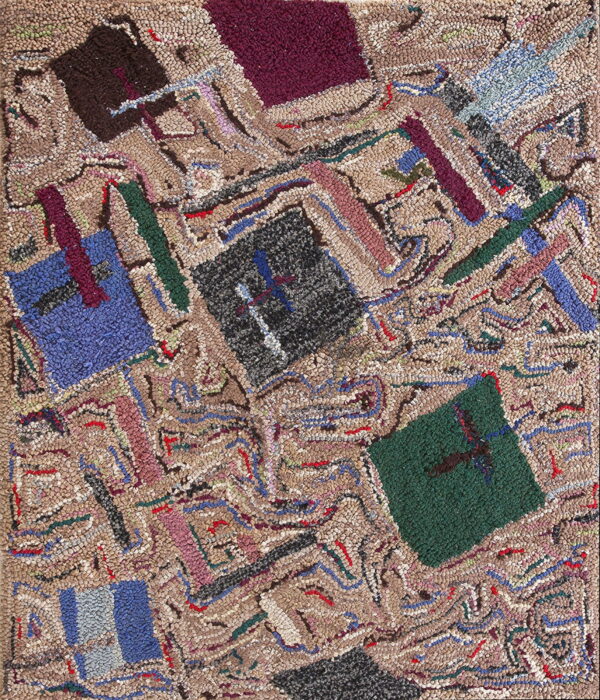 Textured rug featuring an abstract patchwork pattern with dark blue, green, burgundy, and black shapes on a beige ground.