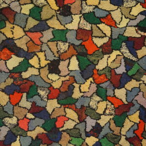 A heavily textured rug displays colorful abstract shapes in reds, greens, blues, browns, and yellows.