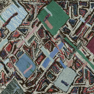 Heavily textured rug featuring abstract diagonal blocks of blue, green, burgundy, and pink over a dark patterned background.