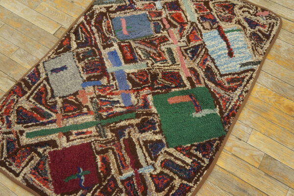Abstract shaggy rug in bold jewel tones and brown, displayed on light rustic wood planks.