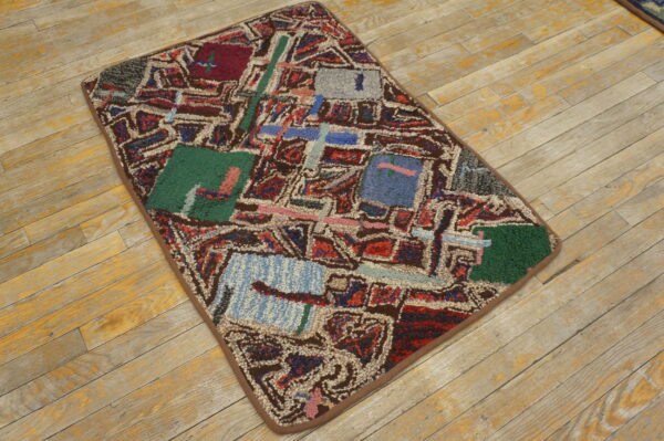 High-pile abstract rug in shades of green, red, blue, and brown rests on rustic light plank wood floor.