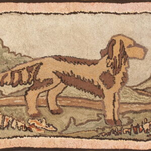 A hooked rug featuring a brown and tan dog in a green landscape with a textured pink outer border.