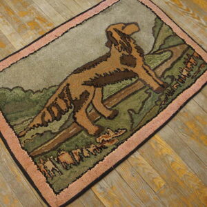 Textured area rug showing a brown dog scene in green and gray, bordered by salmon pink on wood floor.