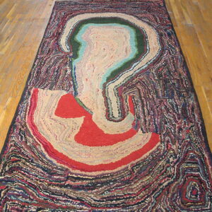 Abstract multicolored rug runner featuring beige, green, red, and blue organic layers on a wood floor.