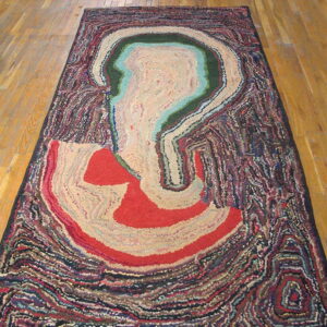 Abstract rug with cream, red, green, and teal shapes bordered by thick, dark, textured swirls on hardwood.