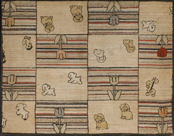 A hooked rug featuring a grid of tan squares with animal outlines and multi-colored striped blocks with tulips.
