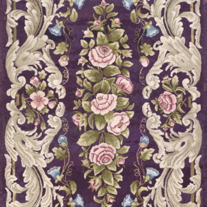 Ornate purple rug with a sculpted floral pattern featuring pink roses, green leaves, and cream baroque scrolls.