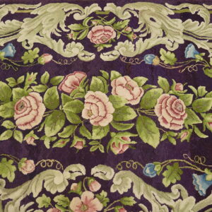 Plush purple rug featuring ornate scrolling sage green leaves and pink rose floral motifs.