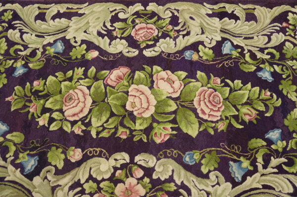Plush purple rug featuring ornate scrolling sage green leaves and pink rose floral motifs.