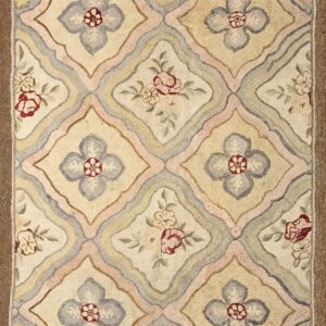 Low-pile rug featuring a cream and yellow ogee trellis pattern with alternating gray and red floral motifs.