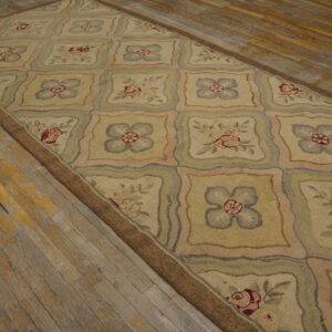 Beige runner rug featuring a lattice design with alternating red roses and blue floral squares on distressed wood flooring.