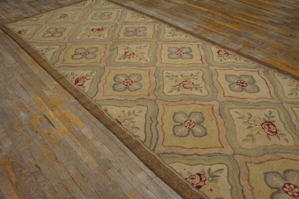 Beige runner rug featuring a lattice design with alternating red roses and blue floral squares on distressed wood flooring.