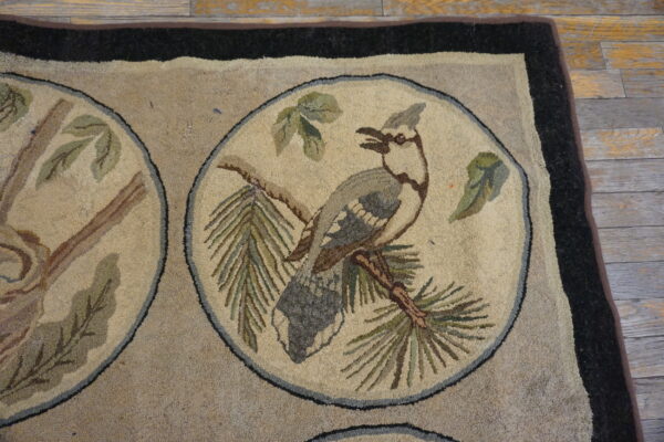 Hooked rug with wildlife medallions showing a gray crested bird on a pine branch against a neutral field.
